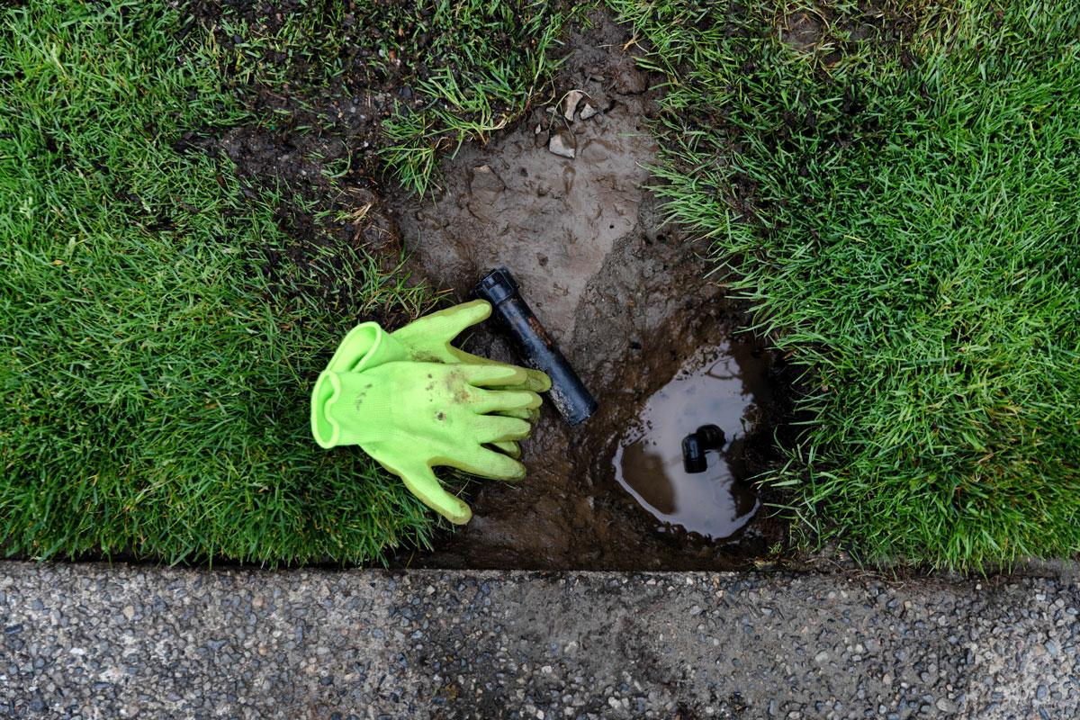 gloves and mud in the grass after Sprinkler System Installation, Lawn Sprinkler Repair, Lawn Sprinkler Systems, and More in Westminster, CO